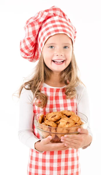 Улыбка милая маленькая девочка в шляпе шеф-повар, держа миску с печеньем Стоковая Картинка