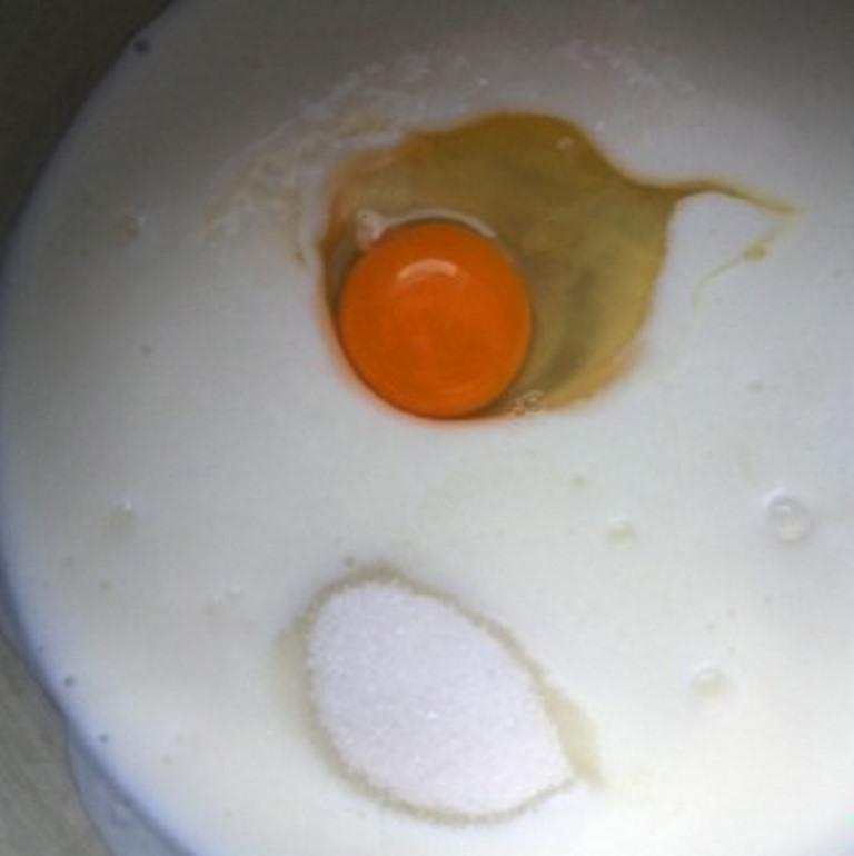 В емкость с кефиром комнатной температуры добавляем яйцо и сахар 